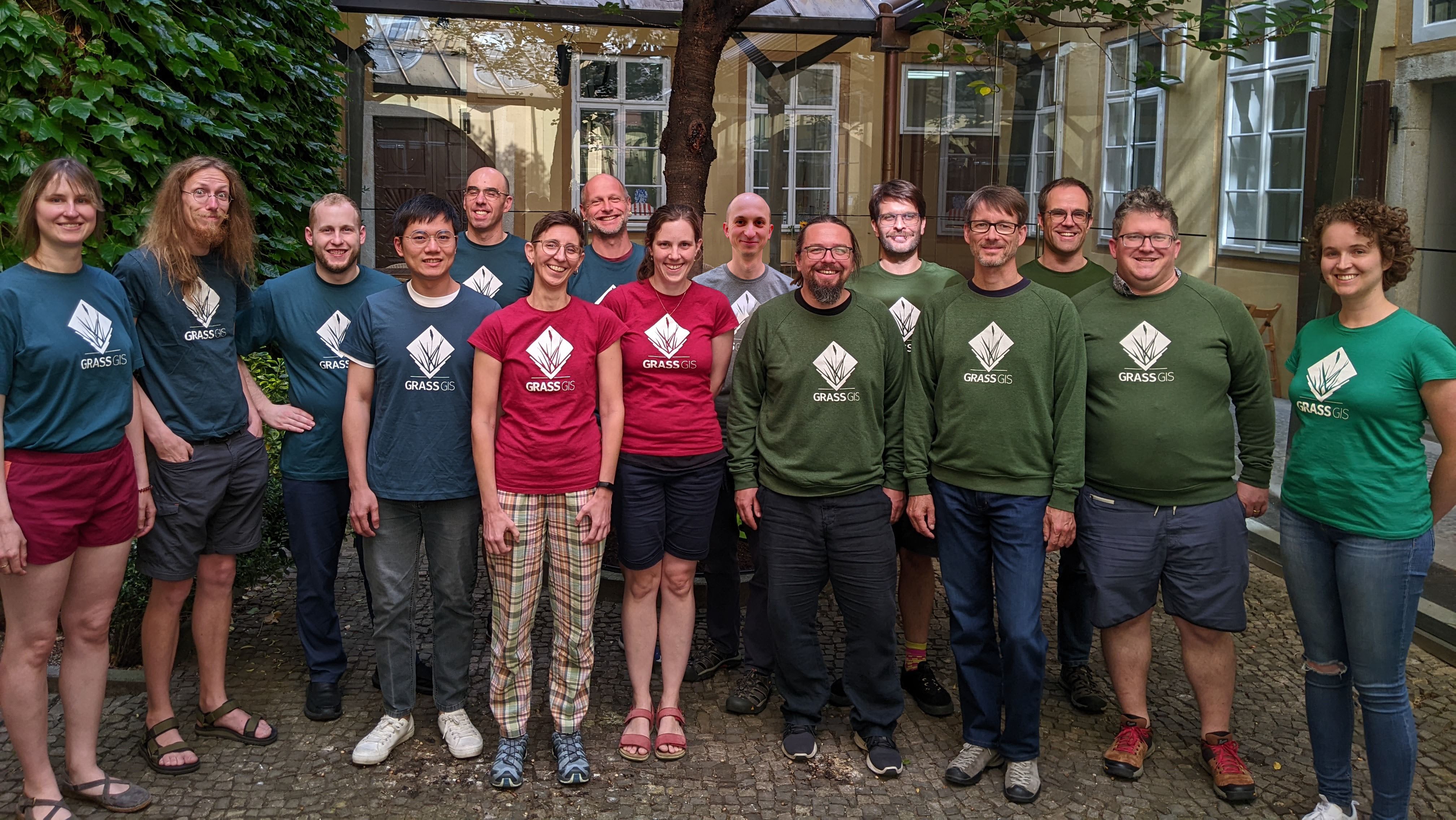 Group of smiling people in GRASS GIS t-shirts